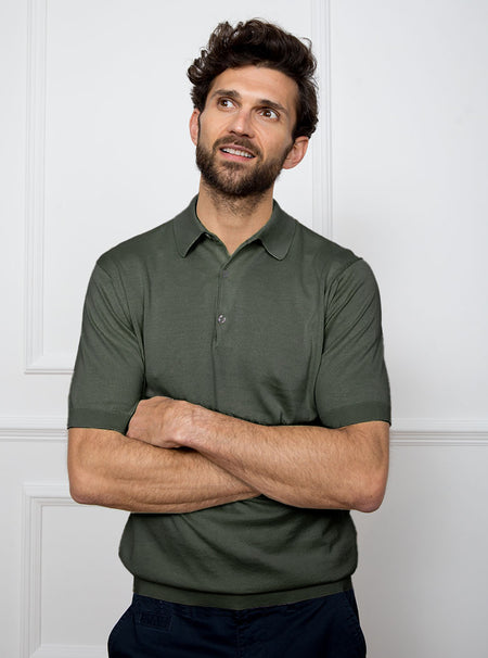 Man wearing palm green short sleeved polo neck knit in a luxury and premium 100% merino wool.